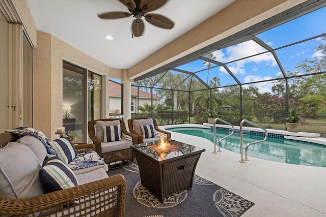 view of pool featuring ceiling fan, a lanai, a patio area, and an outdoor living space