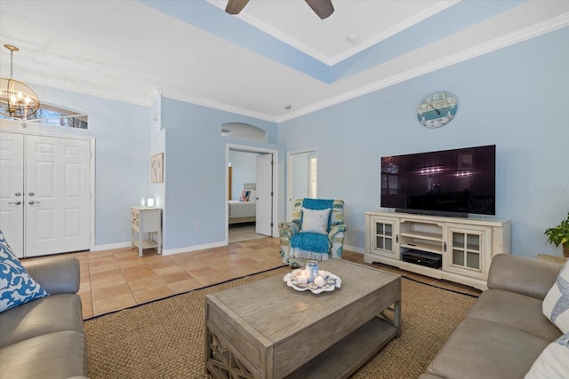 tiled living room featuring ceiling fan with notable chandelier and crown molding