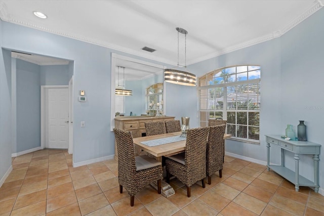 tiled dining area featuring ornamental molding