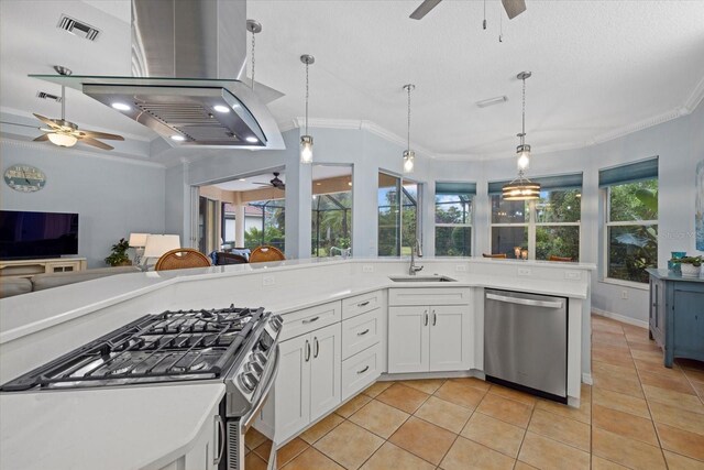 kitchen featuring stainless steel appliances, light tile patterned flooring, pendant lighting, and sink