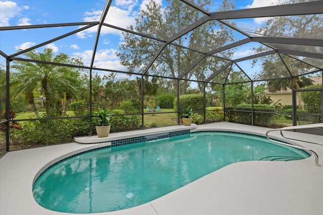 view of pool with glass enclosure