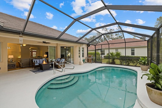 view of pool with ceiling fan, a lanai, outdoor lounge area, a grill, and a patio area