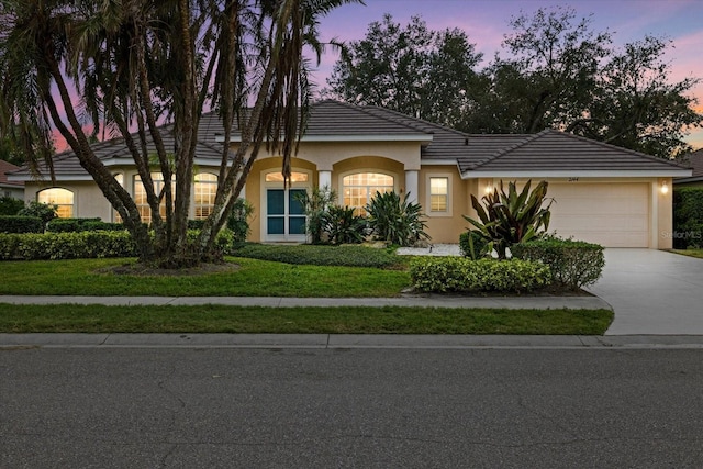 view of front of home featuring a yard and a garage