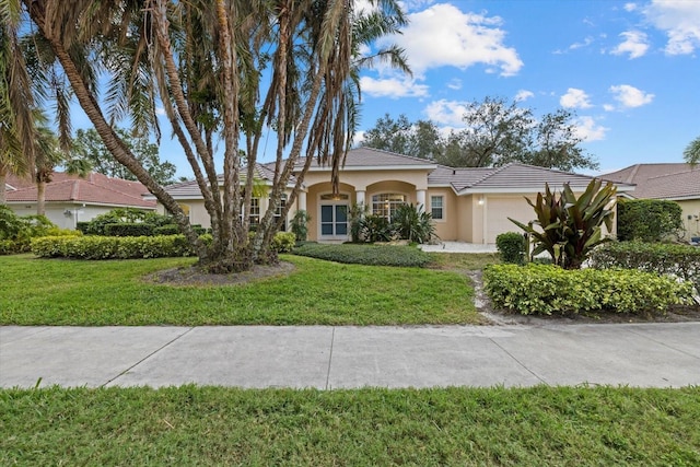 view of front of home featuring a front lawn and a garage