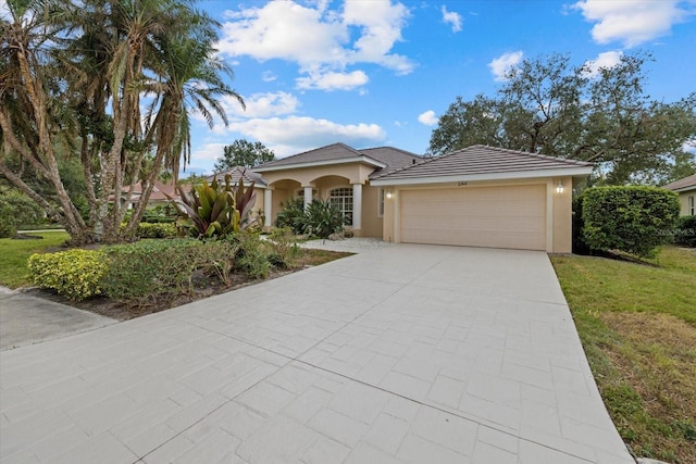 view of front of property featuring a front yard and a garage