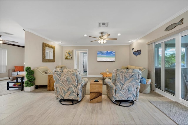 living room featuring ceiling fan, ornamental molding, and light hardwood / wood-style floors