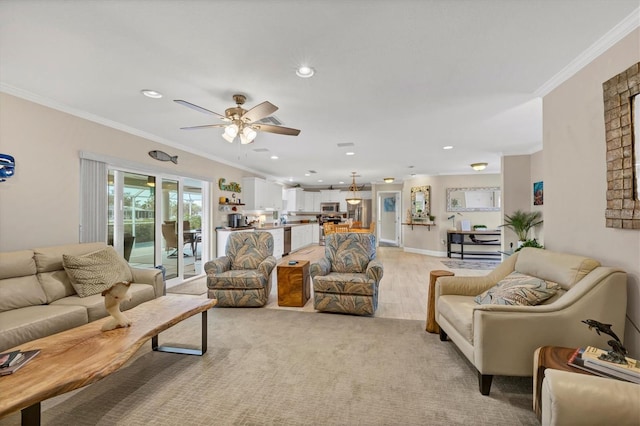 living room with ceiling fan, crown molding, and light hardwood / wood-style floors