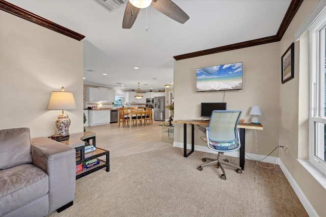 office area with ceiling fan, crown molding, light colored carpet, and a healthy amount of sunlight