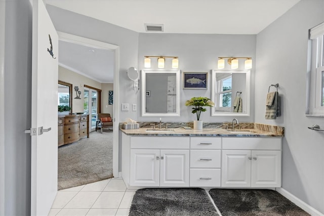 bathroom featuring tile patterned floors, vanity, ornamental molding, and a healthy amount of sunlight