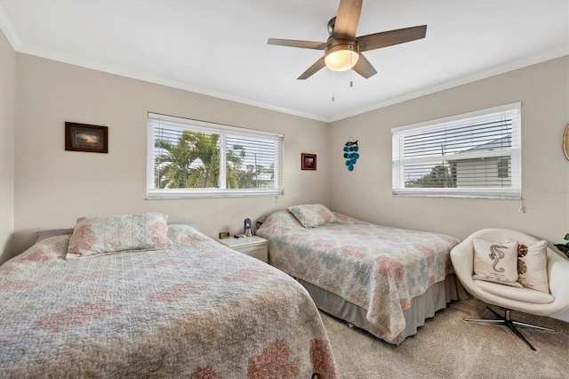 carpeted bedroom featuring ceiling fan, ornamental molding, and multiple windows