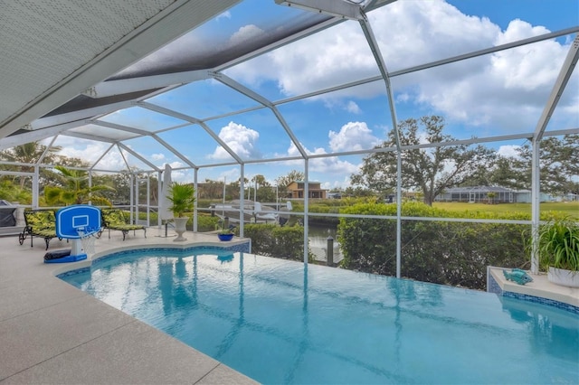 view of swimming pool featuring a lanai and a patio