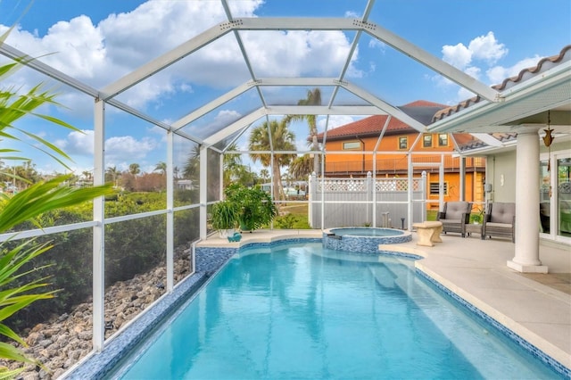 view of swimming pool featuring glass enclosure, an in ground hot tub, and a patio