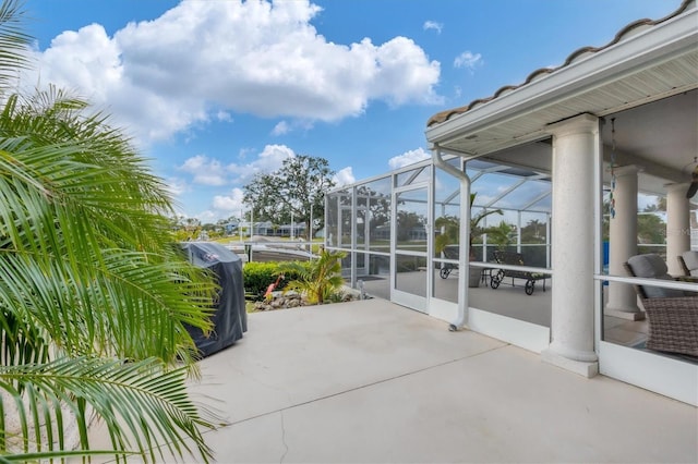 view of patio / terrace featuring a lanai