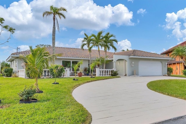 mediterranean / spanish-style house with a garage and a front yard