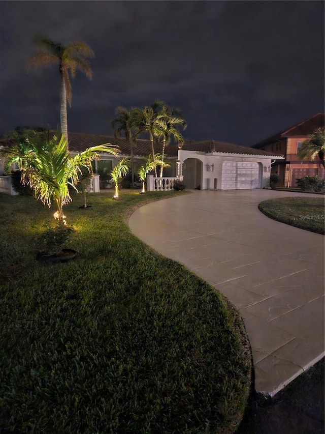 view of front of home featuring a garage and a yard