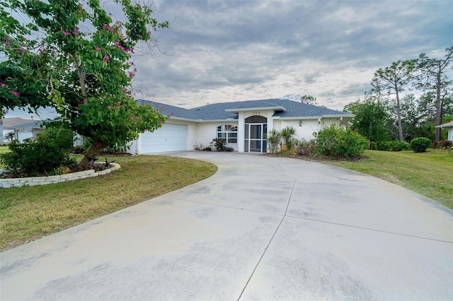 ranch-style home featuring a garage and a front yard