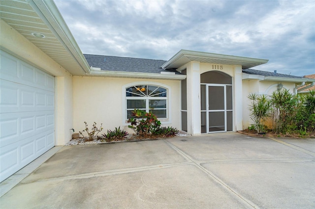 view of exterior entry with a garage