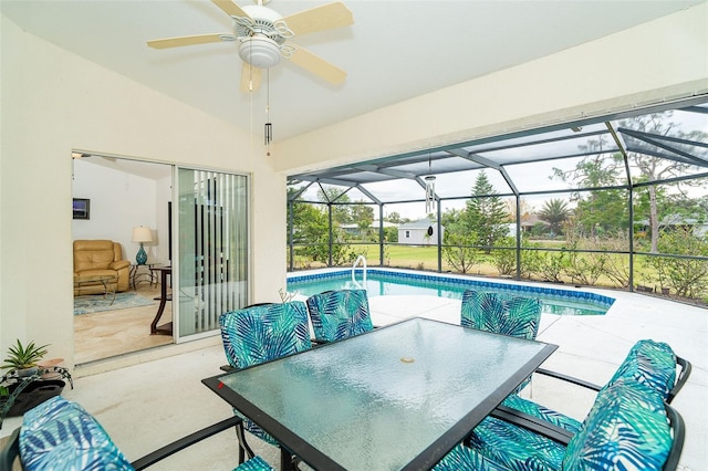 view of swimming pool featuring a lanai, ceiling fan, and a patio area