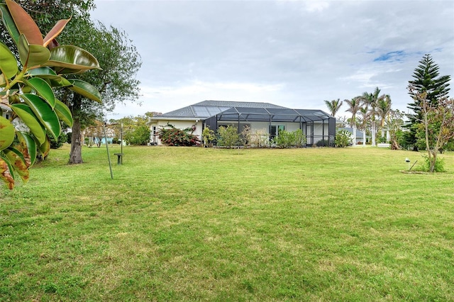 view of yard with glass enclosure