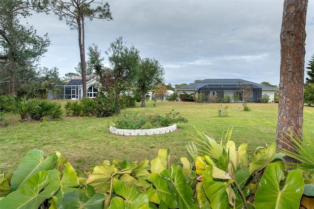 view of yard with glass enclosure