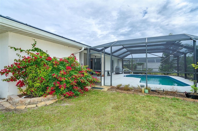 view of swimming pool featuring a lawn and a patio