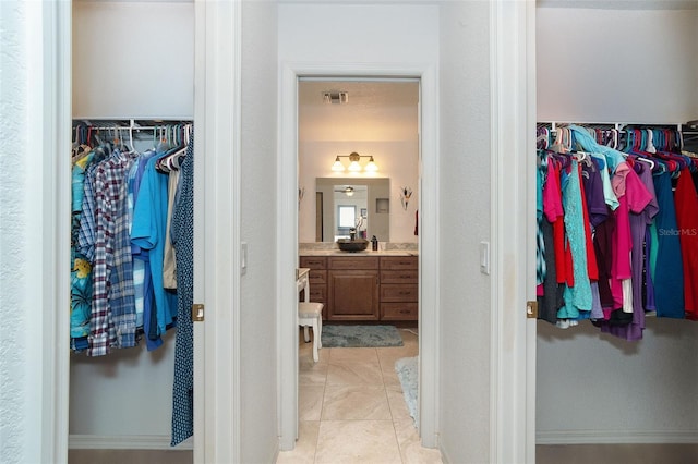 spacious closet featuring light tile patterned floors