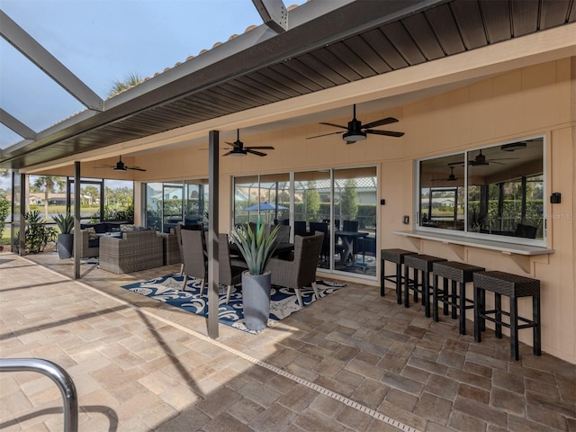 view of patio featuring ceiling fan, a bar, and an outdoor hangout area