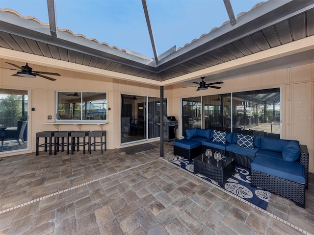 view of patio / terrace featuring ceiling fan, an outdoor bar, outdoor lounge area, and grilling area