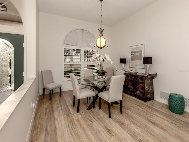 dining room with a wealth of natural light and light hardwood / wood-style flooring