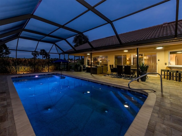 view of swimming pool featuring a lanai and a patio