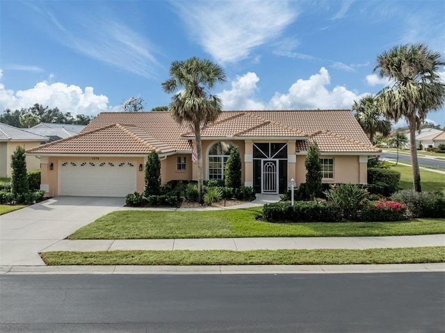 mediterranean / spanish-style house with a garage and a front lawn