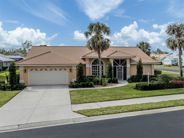 mediterranean / spanish-style home with a garage and a front yard