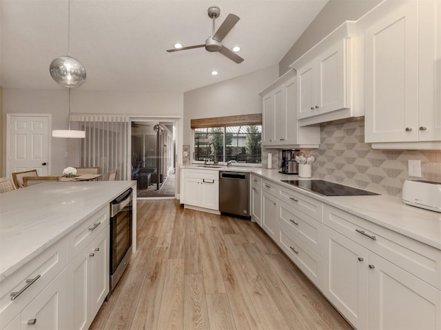 kitchen featuring stainless steel dishwasher, white cabinetry, decorative backsplash, a ceiling fan, and black electric stovetop