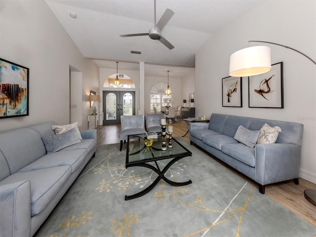 living room featuring visible vents, french doors, wood finished floors, and a ceiling fan