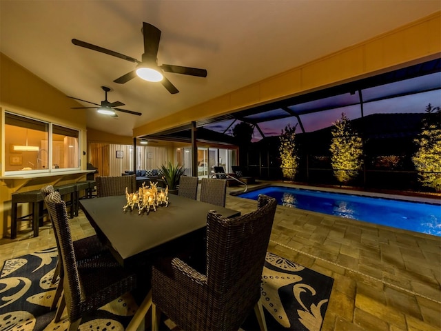 exterior space featuring an outdoor pool, a lanai, a ceiling fan, and outdoor dining area