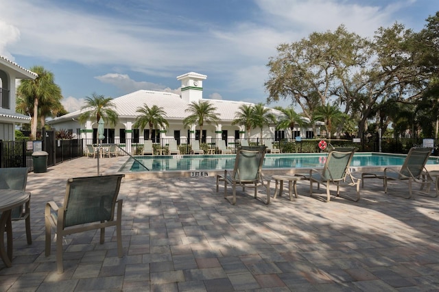 pool with fence and a patio area