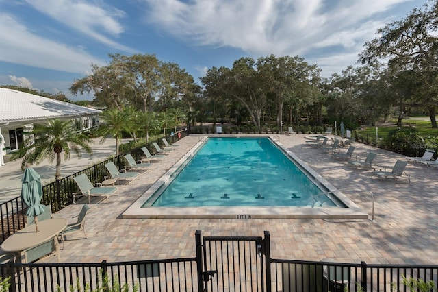 pool featuring a patio and fence