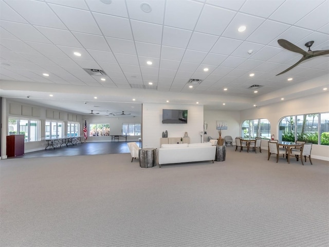 living room with carpet, a wealth of natural light, and visible vents