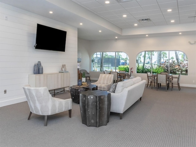 carpeted living area with baseboards, visible vents, and recessed lighting