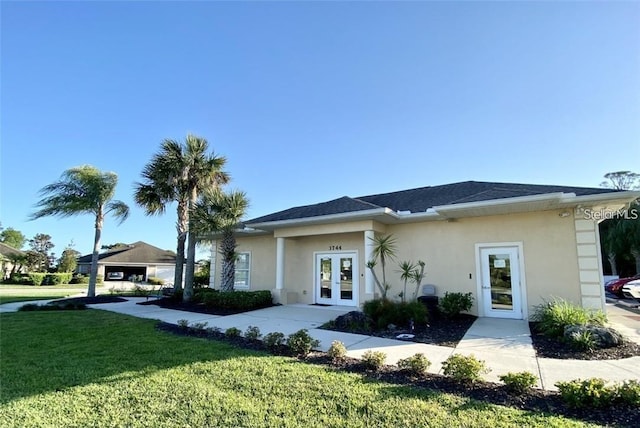 view of front facade featuring french doors and a front yard