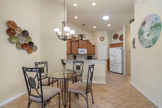 tiled dining room with an inviting chandelier