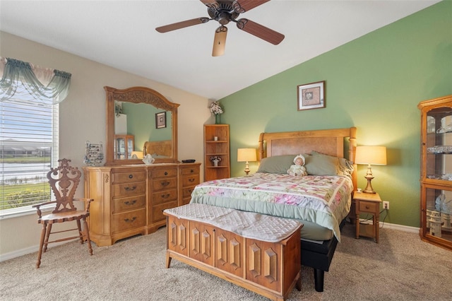 bedroom featuring lofted ceiling, light colored carpet, and ceiling fan