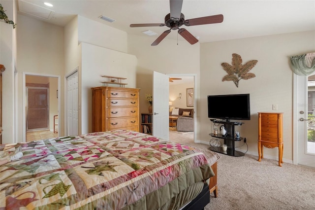 bedroom featuring ensuite bathroom, light carpet, ceiling fan, and a closet