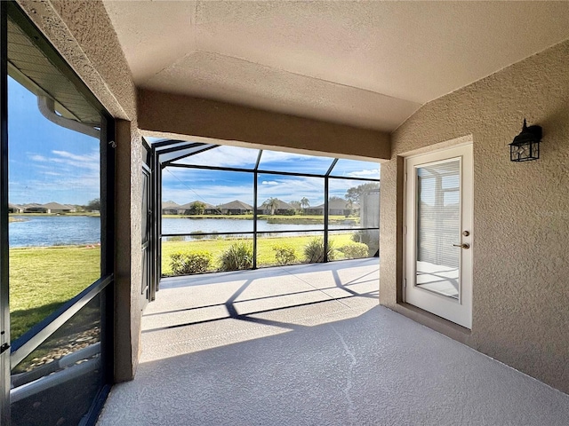 unfurnished sunroom with a water view and vaulted ceiling