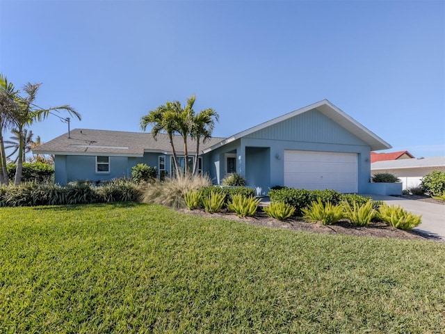 ranch-style house featuring a garage and a front yard