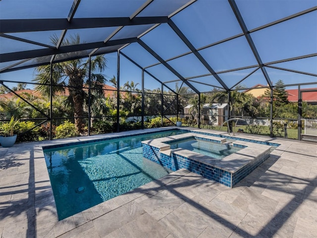 view of pool with an in ground hot tub, glass enclosure, and a patio area