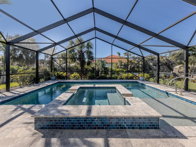 view of pool with an in ground hot tub, a patio area, and glass enclosure