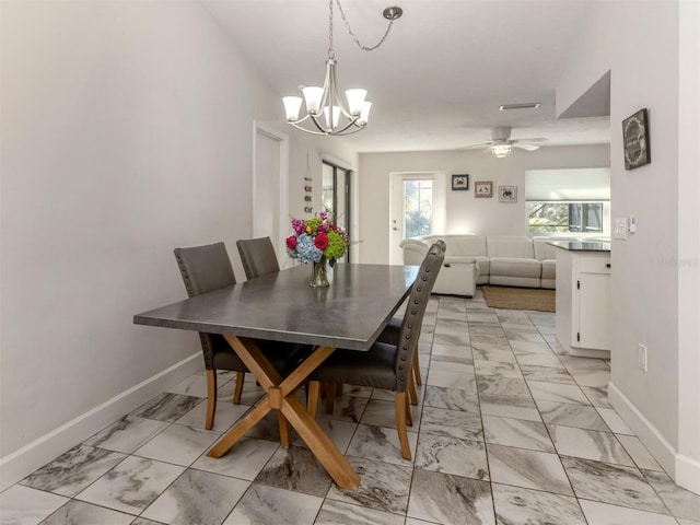 dining area with ceiling fan with notable chandelier