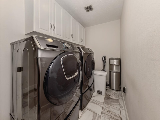 laundry room featuring cabinets and independent washer and dryer