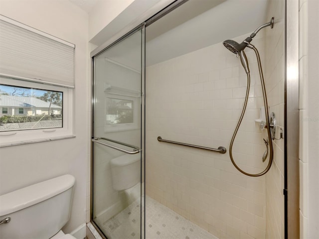 bathroom with toilet and walk in shower